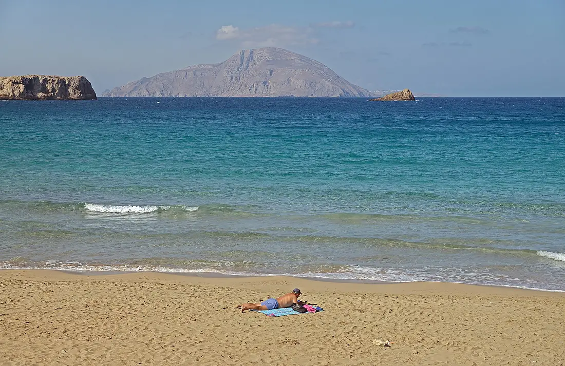 A repose. Agios Nikolaos Beach and Kassos Island, Arkasa. Karpathos, Greece